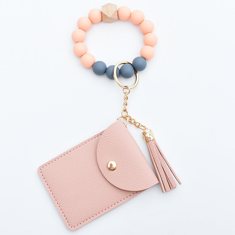 Comercio al por mayor Cuentas de silicona PU Titular de la tarjeta de color sólido Llavero de muñeca